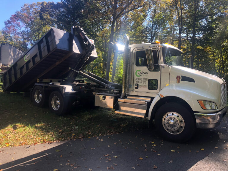 Loading dumpster onto trucj